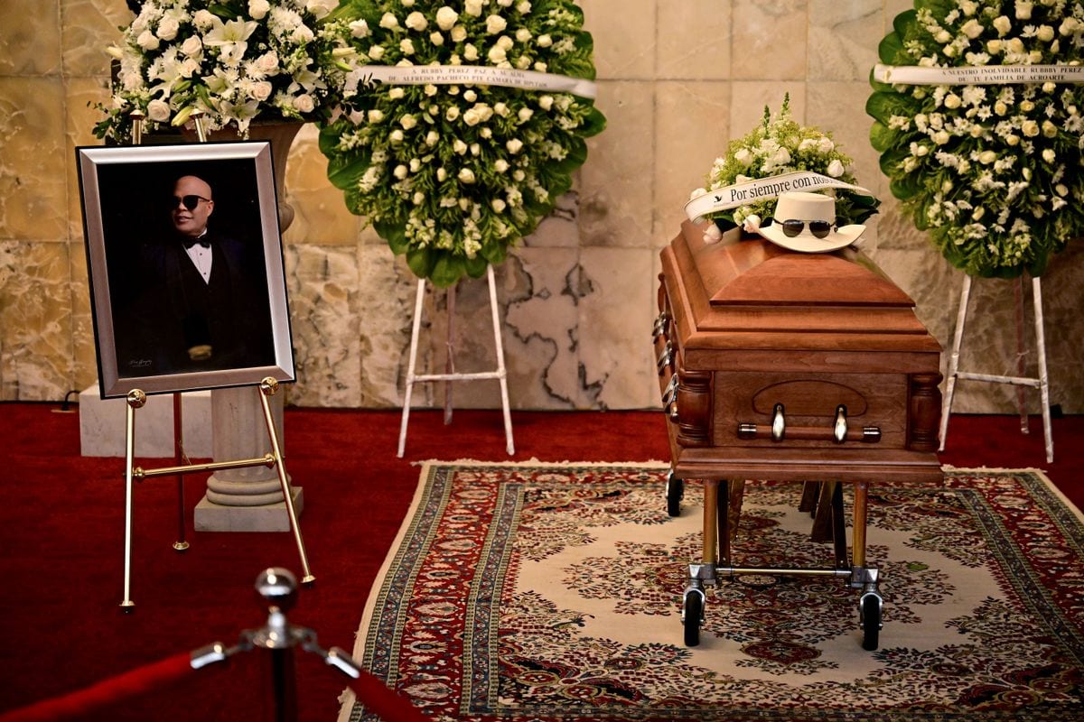 A picture and coffin of famed merengue singer Rubby Perez, who died after the roof of the Jet Set nightclub where he was performing collapsed, is seen during his wake organized by the Minister of Culture at the National Theatre in Santo Domingo on April 10, 2025. 