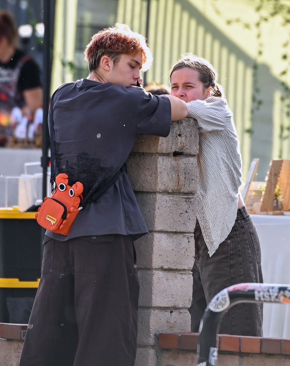 Vivienne was seen taking selfies with her twin brother and they were seen both leaning on a brick pillar.