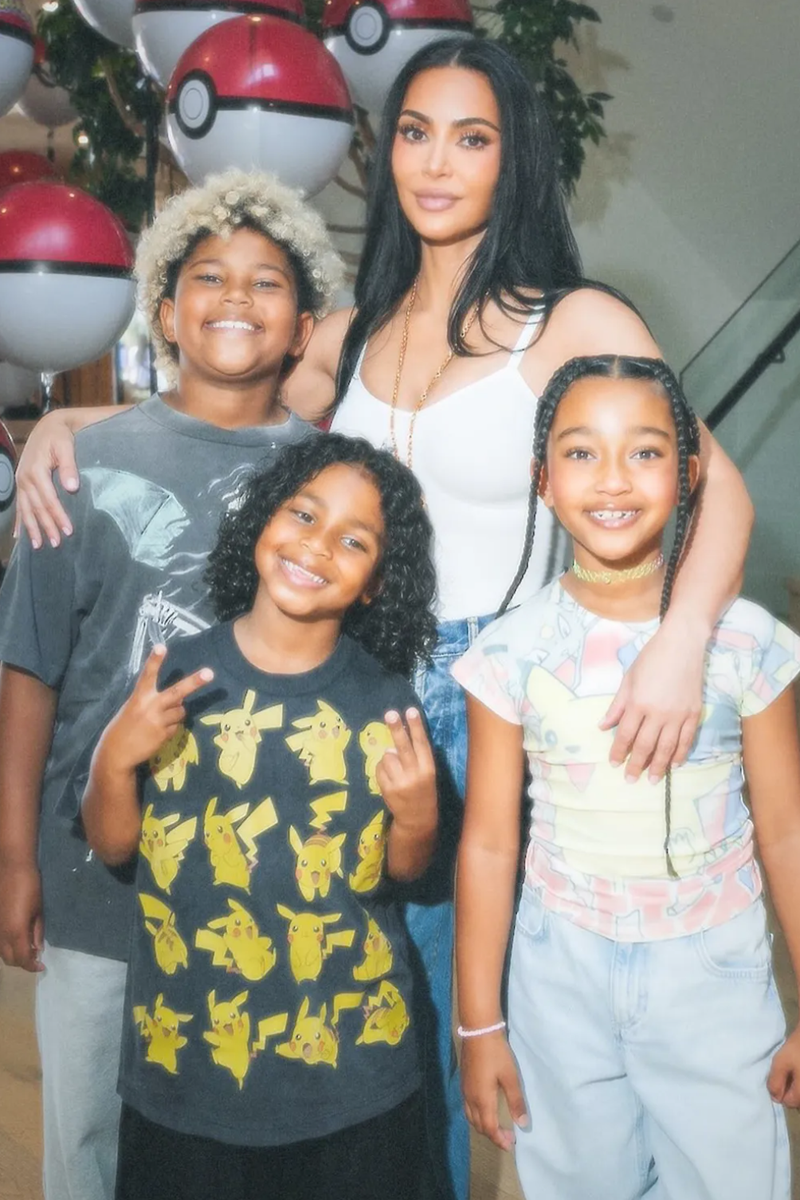 Kim Kardashian is celebrating another major milestone for her youngest son, Psalm West.
The 7-year-old marked his birthday with an elaborate Pokémon-themed party hosted by his mom, Kim Kardashian, who shared photos from the celebration on Instagram on May. The colorful event even featured oversized Poké Ball balloons, trading cards, and even a life-sized Pikachu greeting guests.

The birthday boy leaned fully into the theme, wearing a black Pikachu T-shirt paired with black athletic shorts. Fans may recognize the shirt from the family’s recent Tokyo vacation, where Psalm was also spotted showing off his love for Pokémon.

His siblings joined in on the fun, too. Chicago West, 8, wore a white Pokémon graphic tee featuring fan favorites including Pikachu and Ash Ketchum, while Saint West, 10, opted for a gray graphic T-shirt with light wash jeans.

Although North West, 12, did not appear in the party snapshots, several cousins attended the celebration, including Rob Kardashian’s daughter, Dream Kardashian, 9.
Pokémon is Family Obsession
The Kardashian-West family’s love for Pokémon has become increasingly visible over the past year. Kardashian was previously seen opening Pokémon card packs alongside Saint and Steve Aoki.

According to People, the SKIMS founder also made headlines earlier this year after purchasing a highly coveted BGS 10-graded Hidden Fates Shiny Charizard card, a rare collector’s item beloved by Pokémon enthusiasts.

Since his birth in 2019, Kardashian has openly spoken about the special role Psalm plays within the family.“They love him. He has helped everyone come together,” Kardashian told People in September 2019. “So now everyone gets along. Everyone loves each other. Everyone is helpful. And everyone loves him. Like, obsessed with him,” she added, referring to her kids. 
