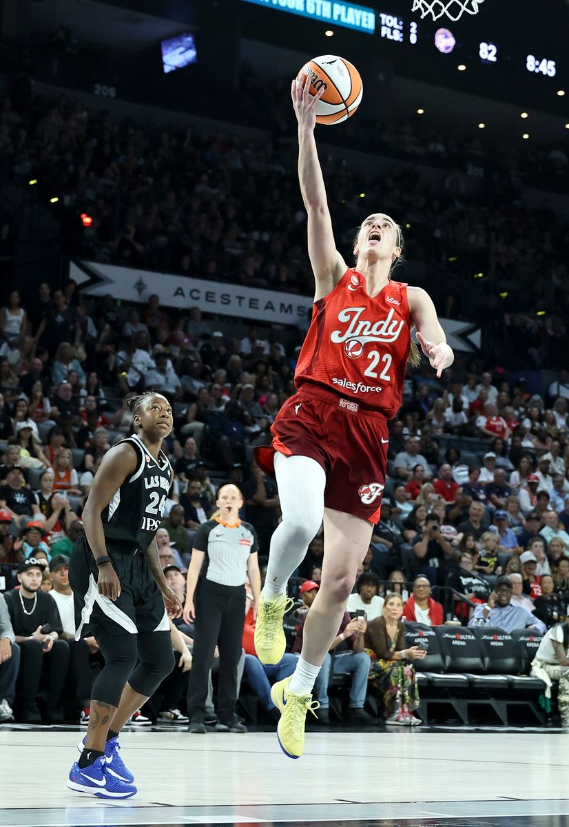 Caitlin Clark #22 of the Indiana Fever shoots a layup ahead of Jewell Loyd #24 of the Las Vegas Aces