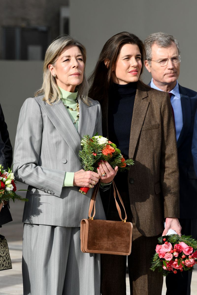 Princess Caroline of Monaco chose a more timeless approach. Her gray-striped suit was paired with a double-breasted blazer featuring wide lapels