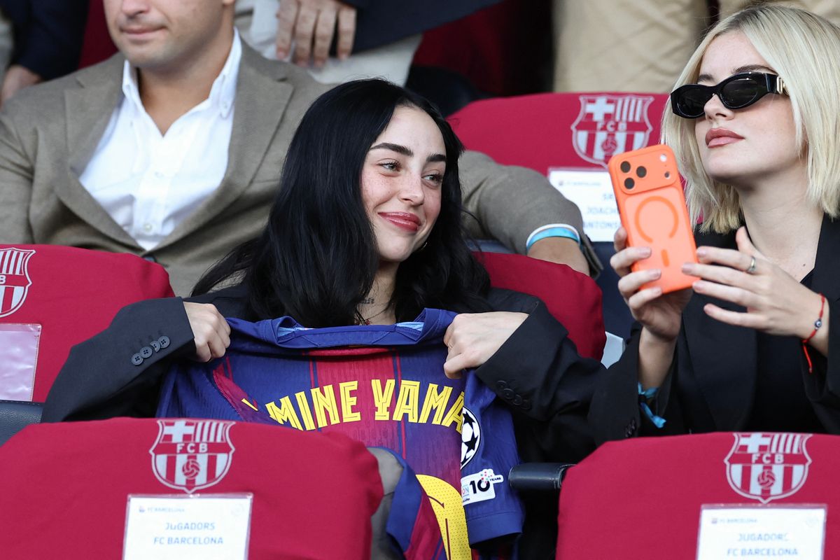 Argentine rapper and singer-songwriter Nicki Nicole (L), girlfriend of Barcelona's Spanish forward #10 Lamine Yamal, attends the UEFA Champions League league phase match-day 3 football match between FC Barcelona and Olympiakos FC at Estadi Olimpic Lluis Companys in Barcelona on October 21, 2025. (Photo by Josep LAGO / AFP) (Photo by JOSEP LAGO/AFP via Getty Images)          