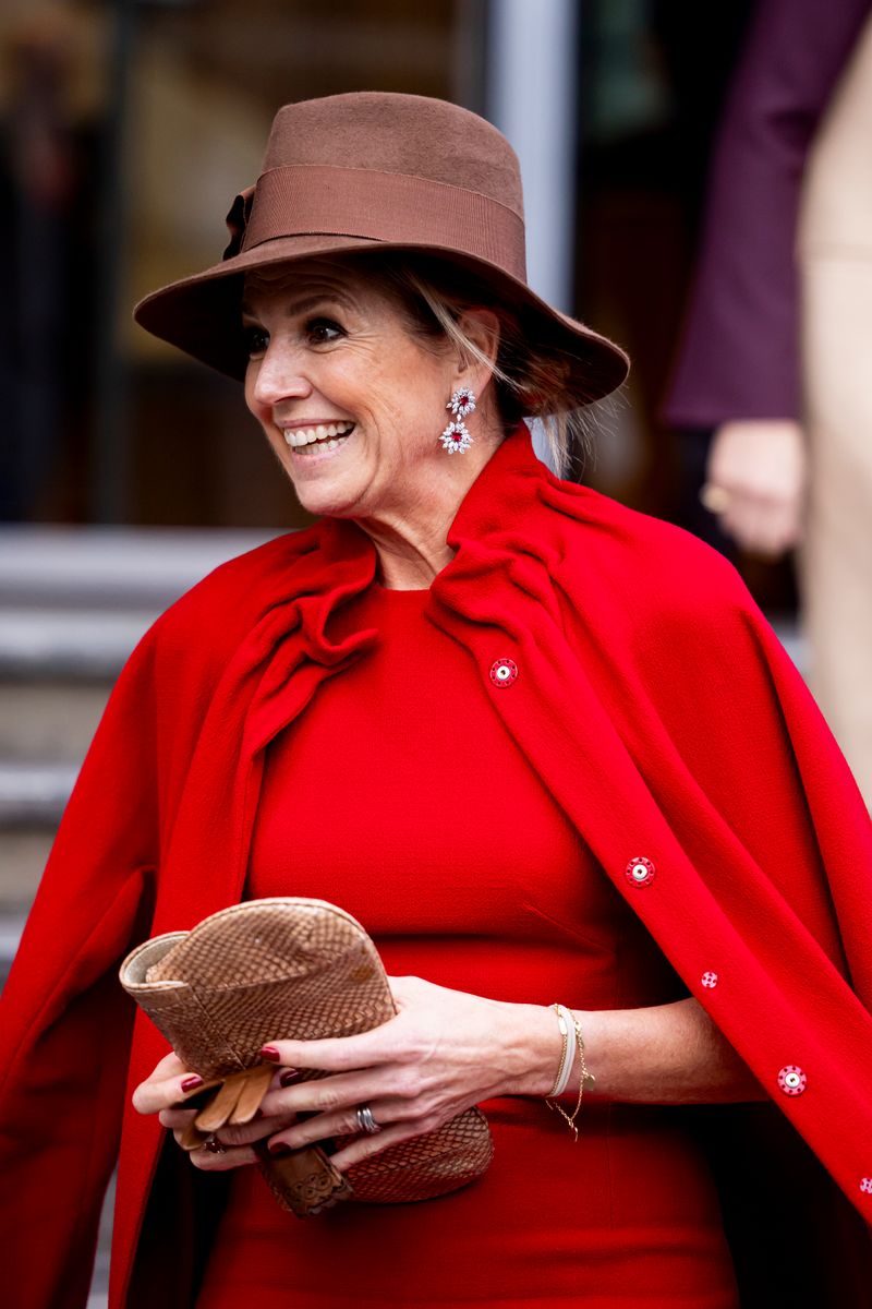 Queen Maxima of The Netherlands completed the outfit with her light-brown Bean handbag by Sophie Habsburg