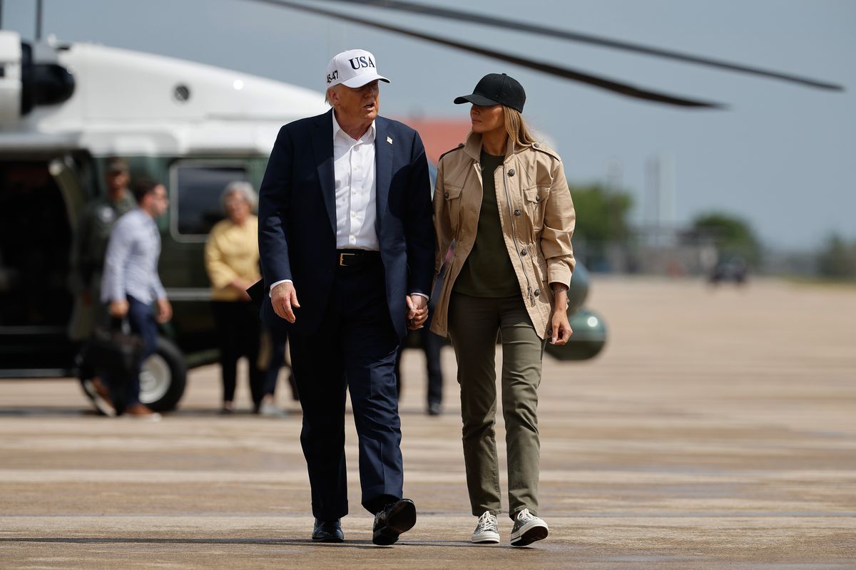 President Donald Trump and first lady Melania Trump visit walk across the tarmac at Lackland Air Force Base after meeting with state and local leaders, first responders and victims of last week's flash flooding on July 11, 2025 in San Antonio, Texas. 