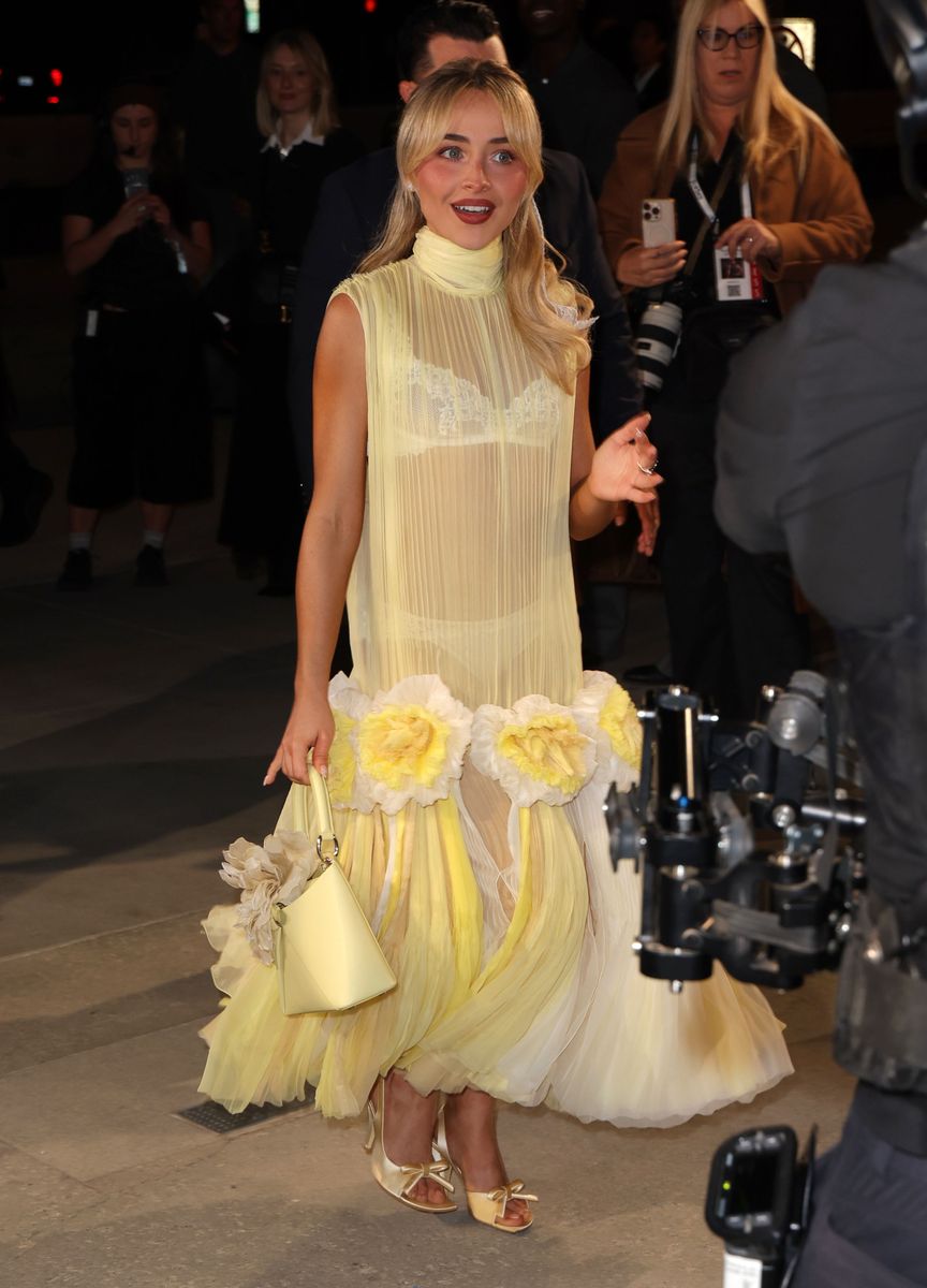 Sabrina wore her blonde hair in loose retro-inspired waves styled in a half-up finish with a delicate bow.