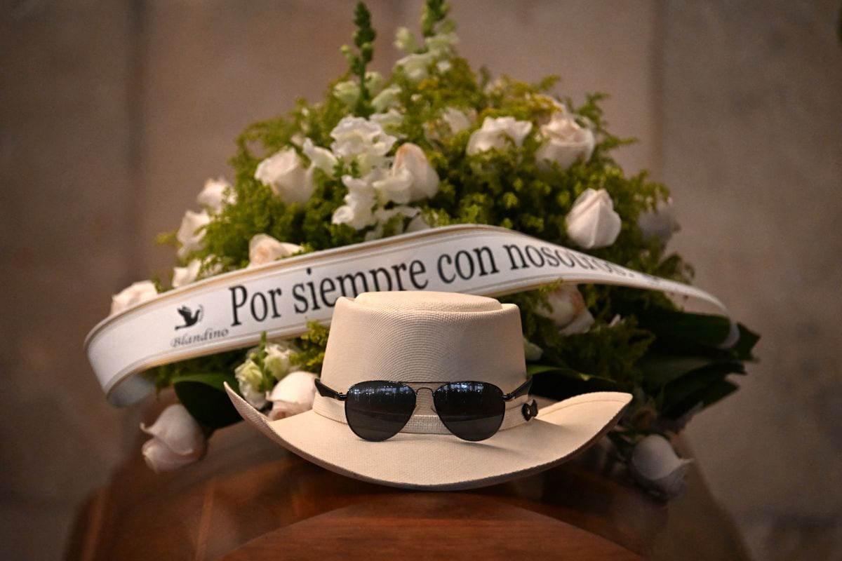 A hat and sunglasses placed over the coffin of famed merengue singer Rubby Perez, who died after the roof of the Jet Set nightclub where he was performing collapsed, are seen during his wake organized by the Minister of Culture at the National Theatre in Santo Domingo on April 10, 2025.