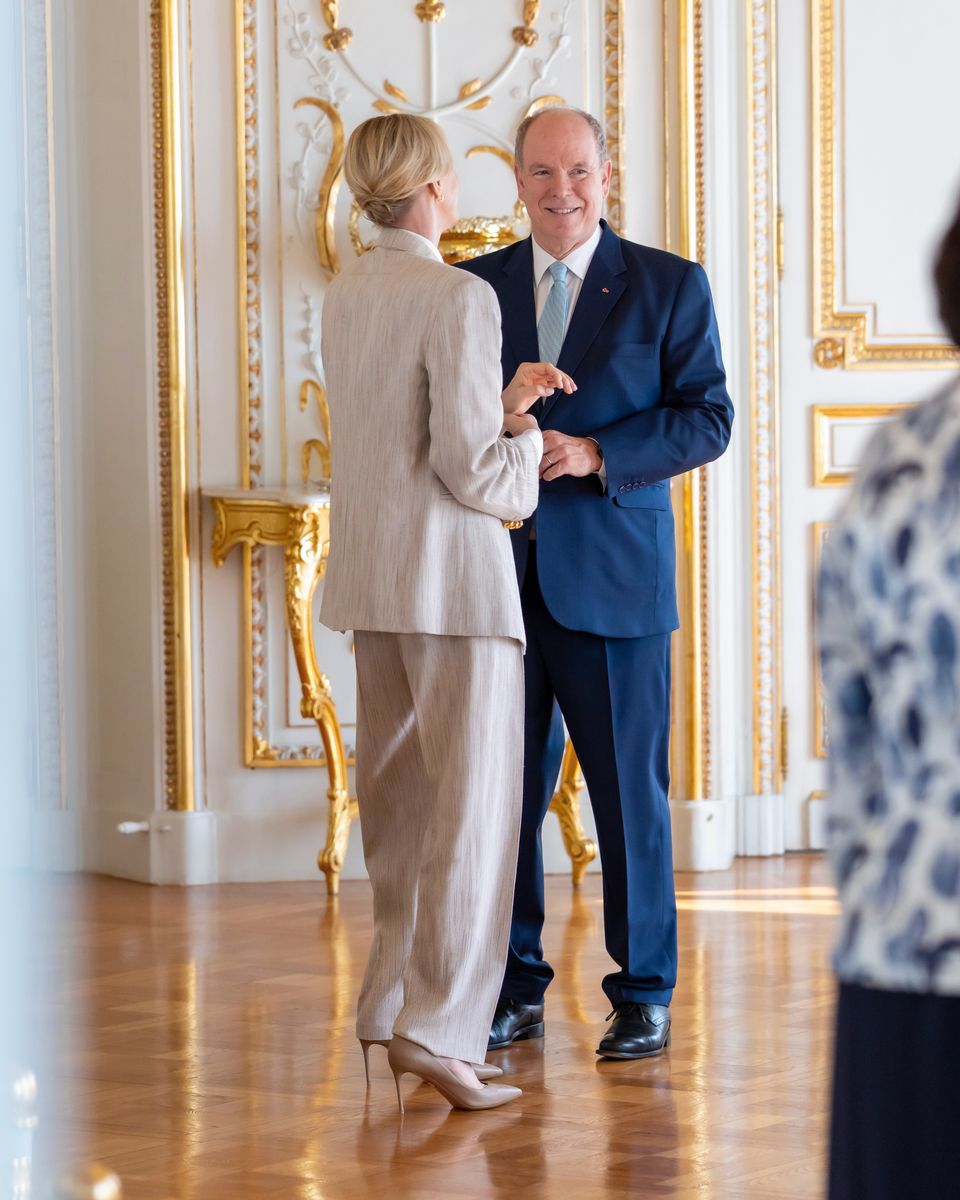 The Monegasque royal paired her relaxed tailored suit with a crisp white shirt, gold earrings and a sleek low updo.