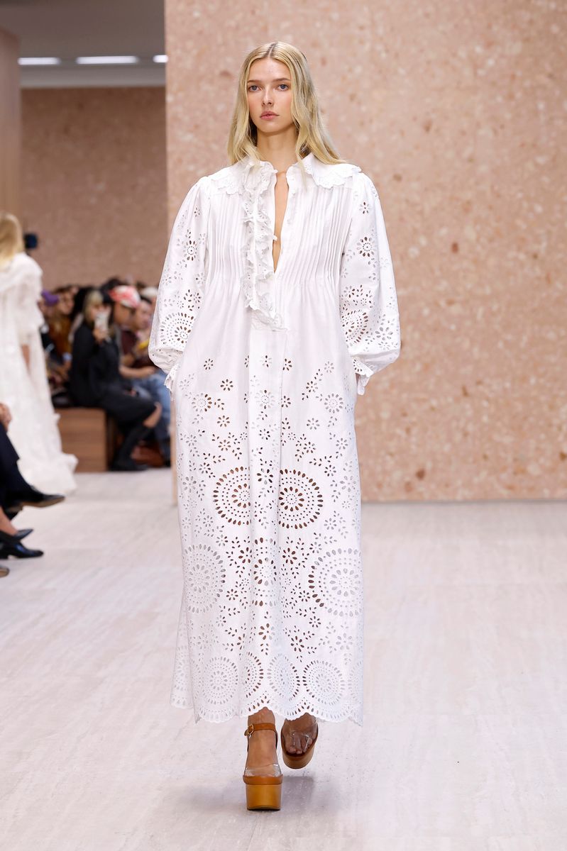 Apple Martin makes her runway debut at Paris Fashion Week, walking for Chloé in a plunging white dress as her fashion and acting career takes off.