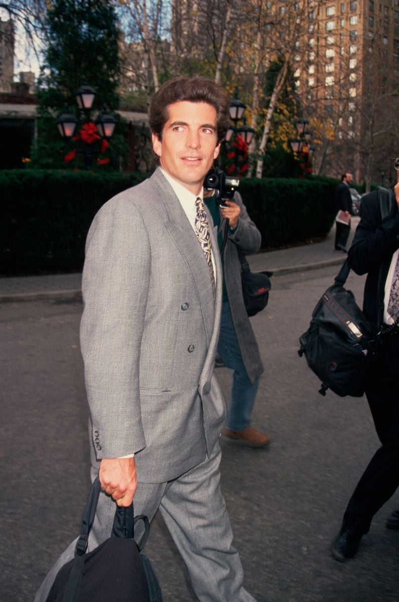 Paparazzi photographers take pictures of John F. Kennedy, Jr. on a New York City street.   (Photo by Mitchell Gerber/Corbis/VCG via Getty Images)