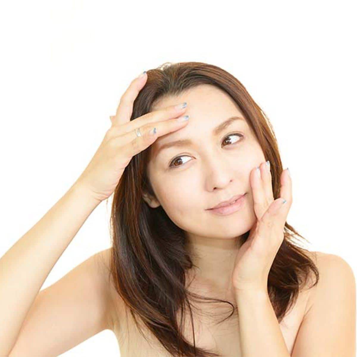 Mujer se da un masaje facial