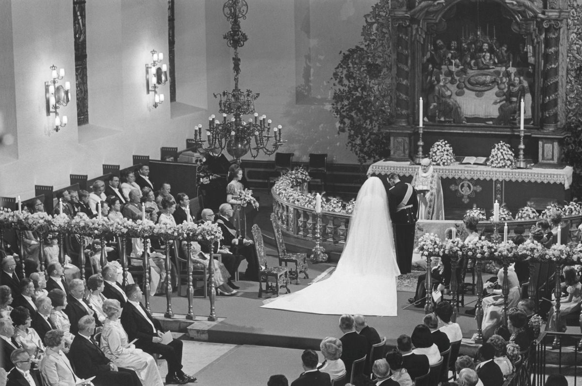 King Olav V accompanied Sonja into Oslo Cathedral after finally giving the couple permission to marry.