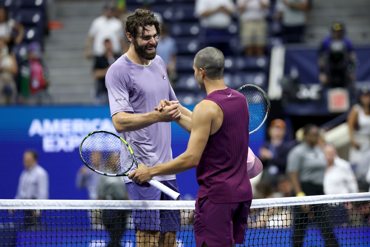 Carlos Alcaraz of Spain greets Reilly Opelka of the United States following their Men's Singles First Round match on Day Two of the 2025 US Open 