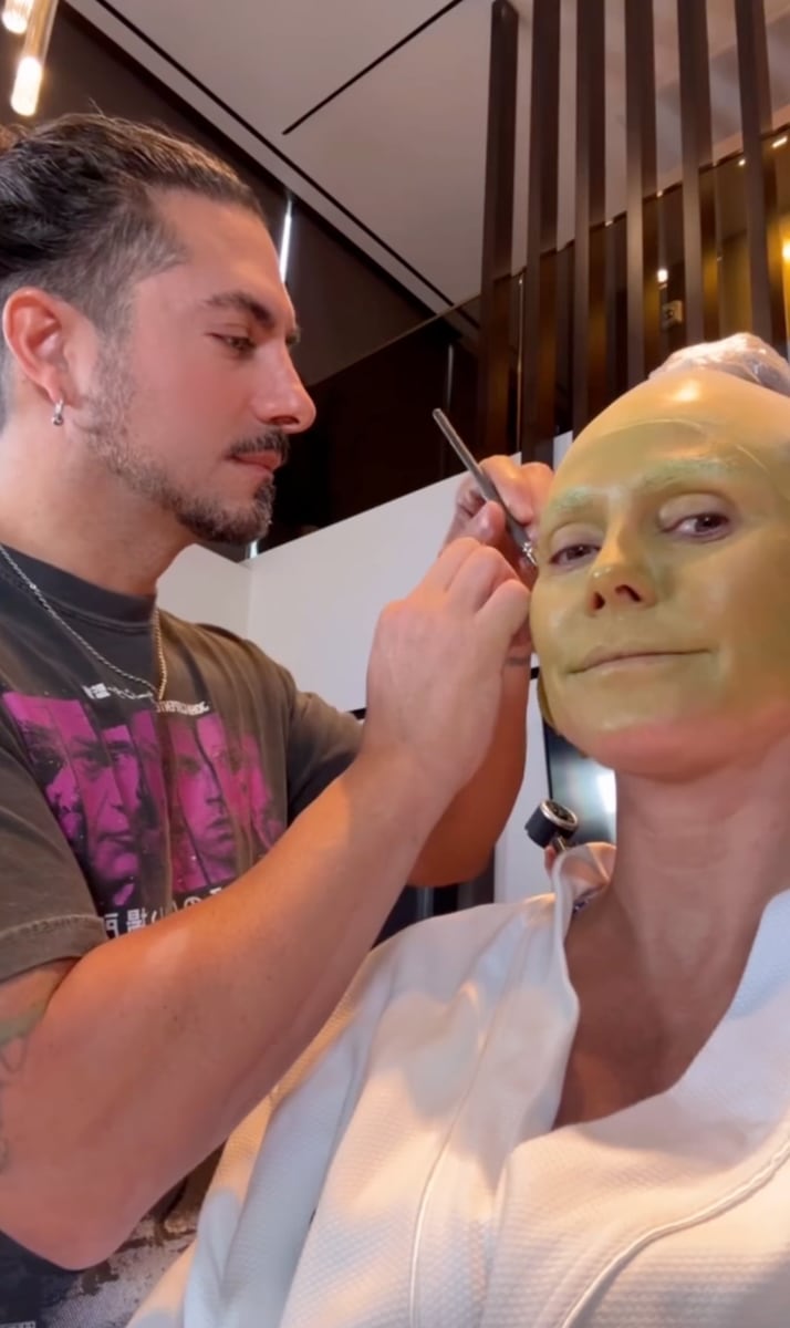 Klum shared a close-up of sharp teeth, a video with greenish face paint, and another of herself undergoing prosthetic application.