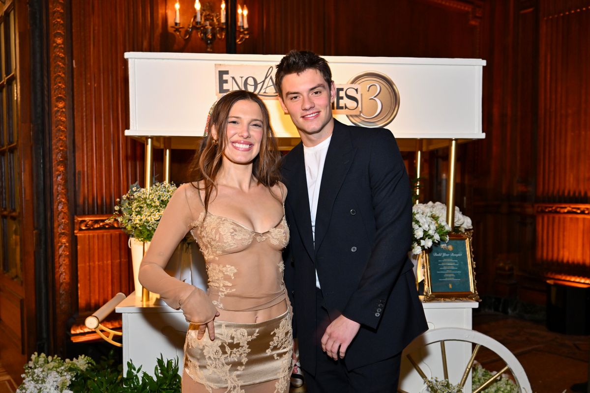 Millie Bobby Brown posed alongside 'Enola Holmes 3' co-star Louis Partridge as the cast celebrated the film's world premiere in New York.