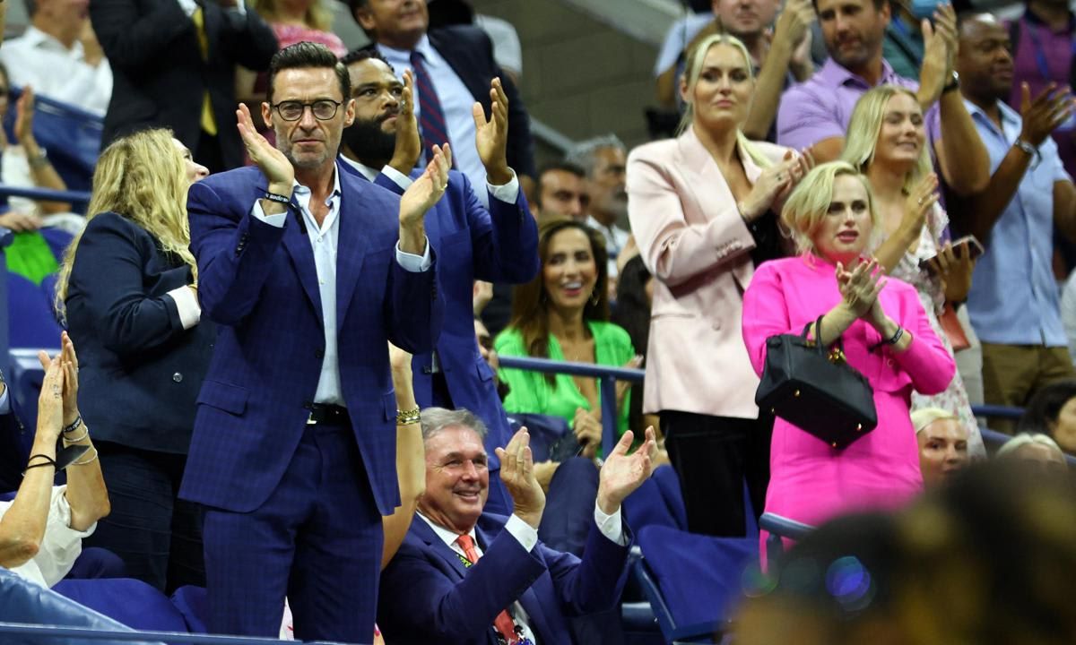 Hugh Jackman looked classy in a navy suit and was on his feet cheering.