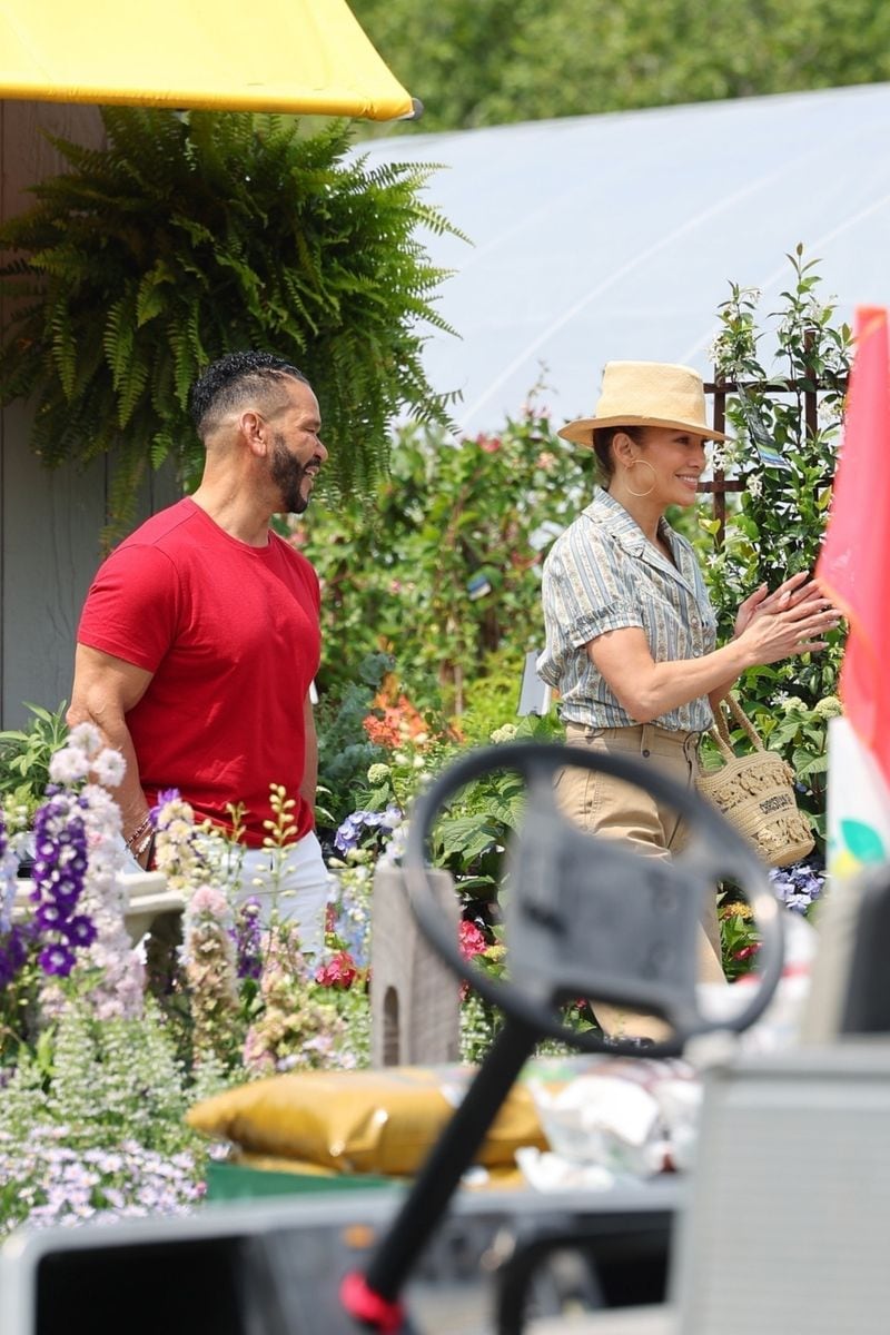 Jennifer Lopez exudes Hamptons chic as she steps out with her manager, Benny Medina, celebrating the Fourth of July by indulging in some plant shopping. The duo looked cheerful as they browsed through a variety of greenery and were seen hauling off about six rose bushes. Meanwhile, husband Ben Affleck was seen last night in LA enjoying some time with his kids. 
