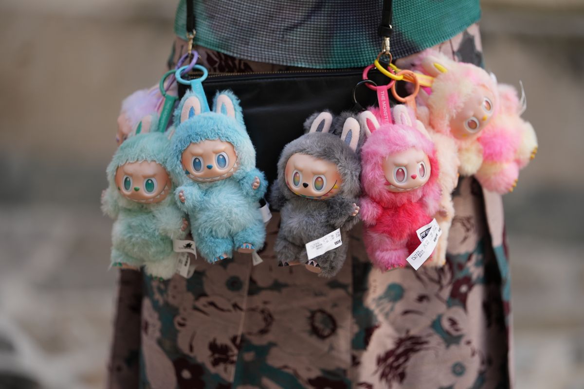Close-up detail view of seven Labubu "Big Into Energy" collection : Loyalty, Happiness, Luck, Hope, Serenity, Love an Secret, during a street style fashion photo session, on June 12, 2025 in Paris, France. (Photo by Edward Berthelot/Getty Images)