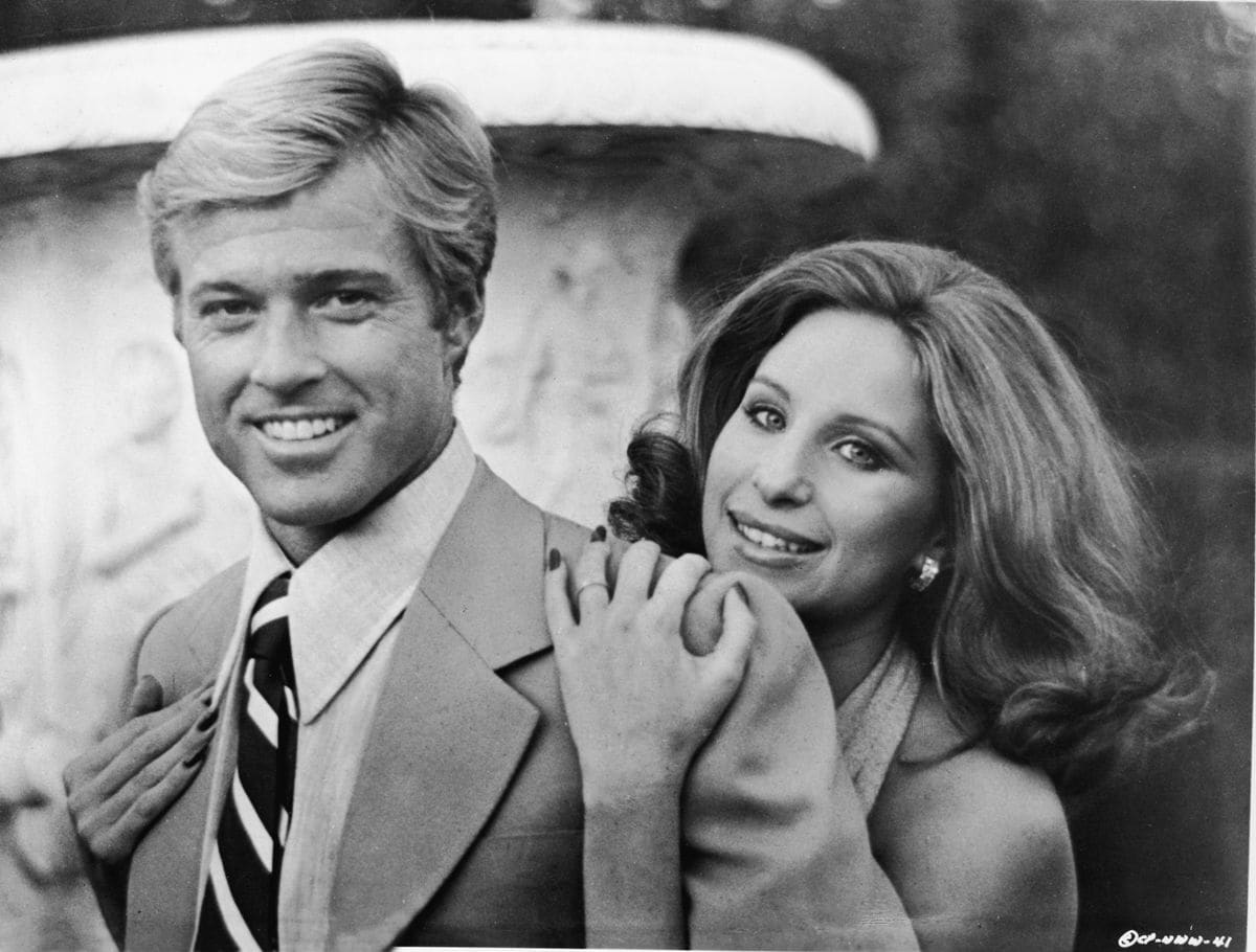 Barbra Streisand hugs American actor Robert Redford from behind in this publicity still from the movie 'The Way We Were' directed by Sydney Pollack, 1973. 