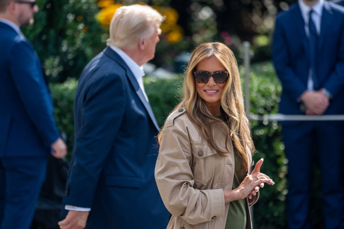 Melania wore a muted olive green tee, keeping the color palette cohesive and grounded