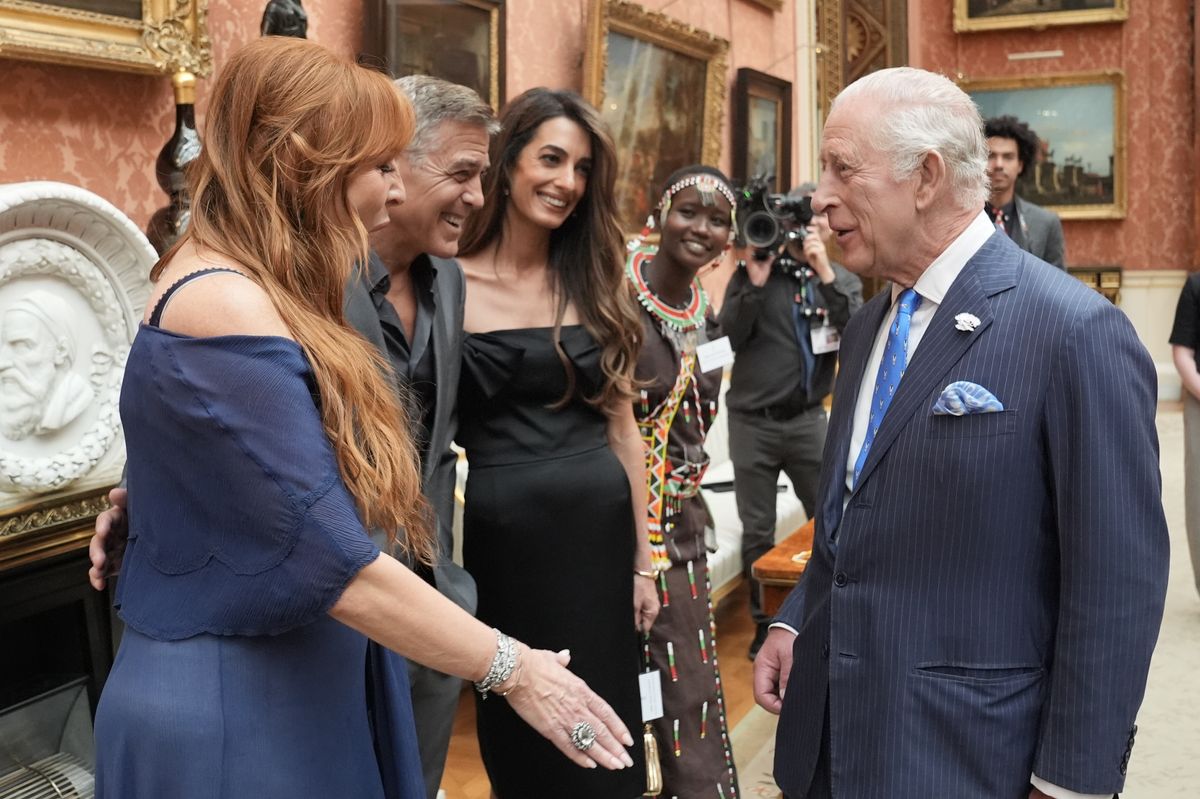 LONDON, ENGLAND - JUNE 25: King Charles III speaks with (left to right) Charlotte Tilbury, George Clooney, Amal Clooney and Alice during a reception for the winners of the King's Trust Awards 2025 at Buckingham Palace on June 25, 2025 in London, England. (Photo by Stefan Rousseau-WPA Pool/Getty Images)