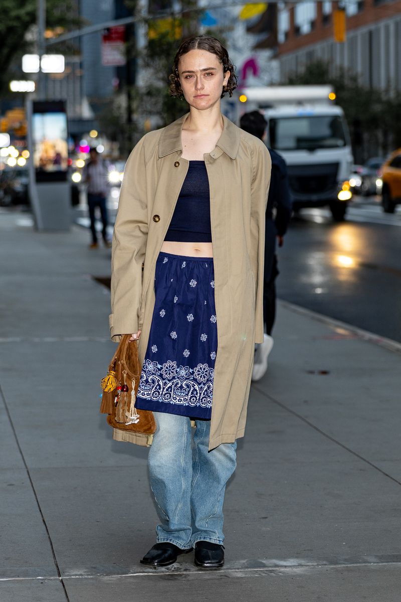 Ella Emhoff attends Miu Miu Tales & Tellers wearing baggy jeans and a blue skirt