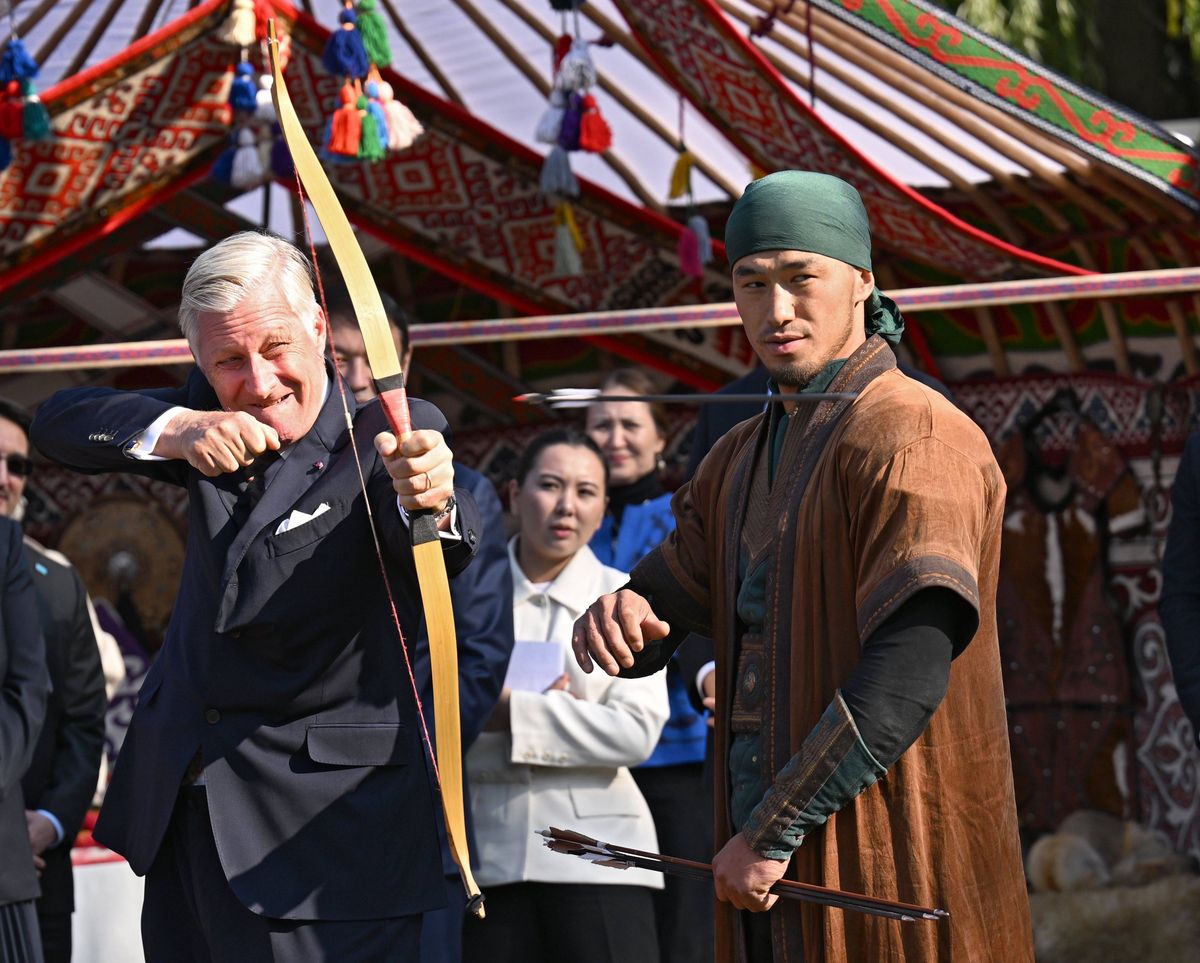 King Philippe joined in the activity, taking aim with guidance from an instructor.