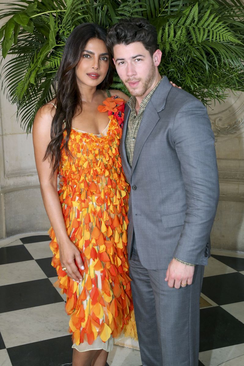 Priyanka Chopra Jonas paired her textured floral dress with elegant bow-detail slingback heels and a burgundy handbag for a polished finish.