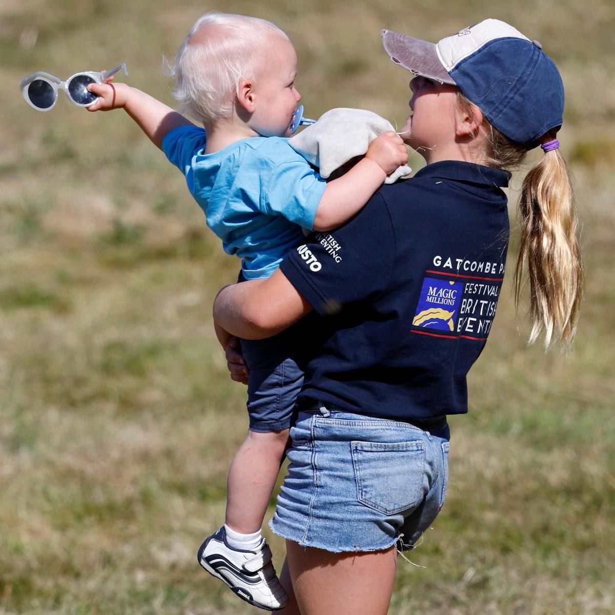 Lucas was pictured taking his sister's sunglasses off of her baseball cap.