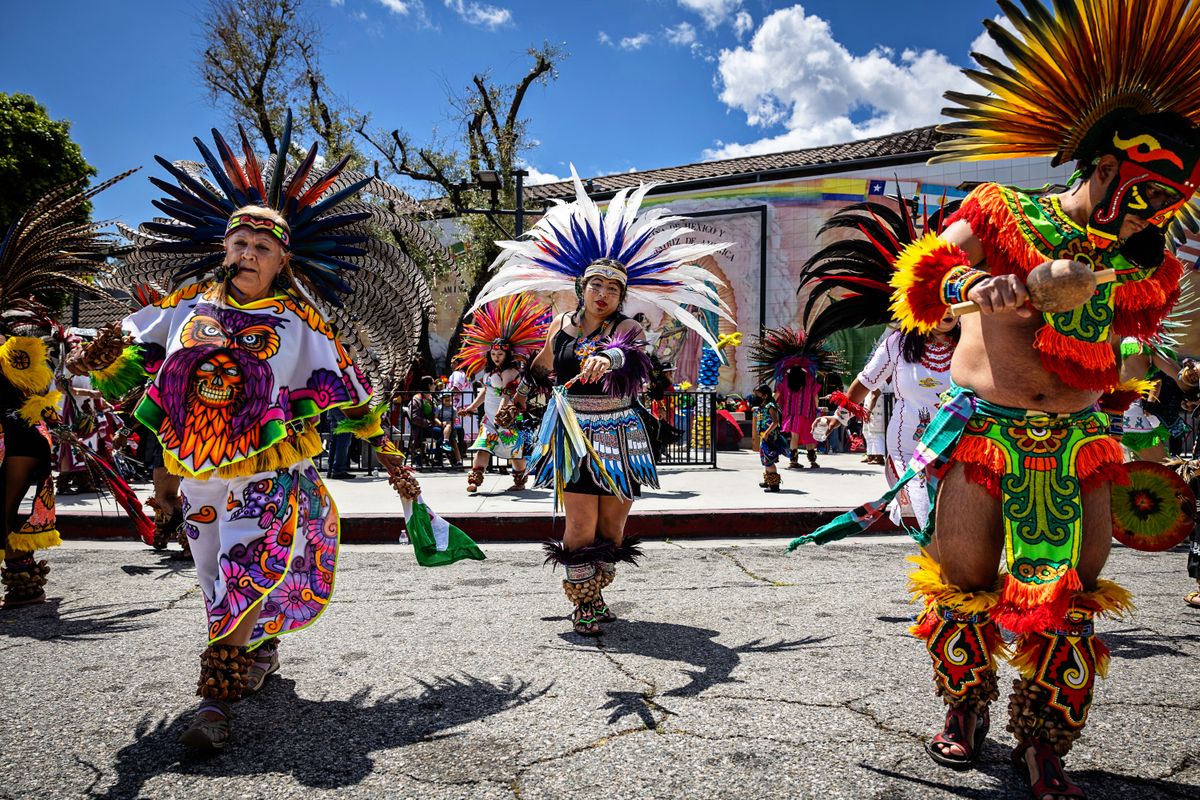 Los Angeles, CA - May 05: Community members perform tradition Aztec dancing at La Placita Olvera Church during the Cinco De Mayo Fiesta at Olvera Street on Sunday, May 5, 2024 in Los Angeles, CA. (Jason Armond / Los Angeles Times via Getty Images) 