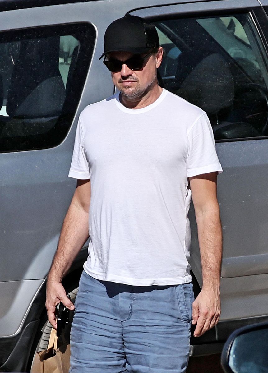 Leonardo DiCaprio keeps his vacation style casual in a white T-shirt, blue shorts, a black baseball cap and sunglasses while enjoying time in Ibiza.