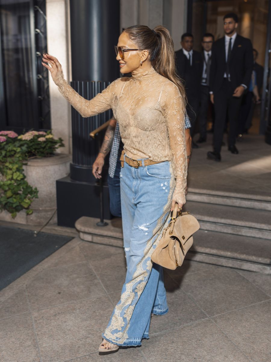 J.Lo coordinated her statement denim with a sheer high-neck lace top and matching lingerie-inspired layer underneath.