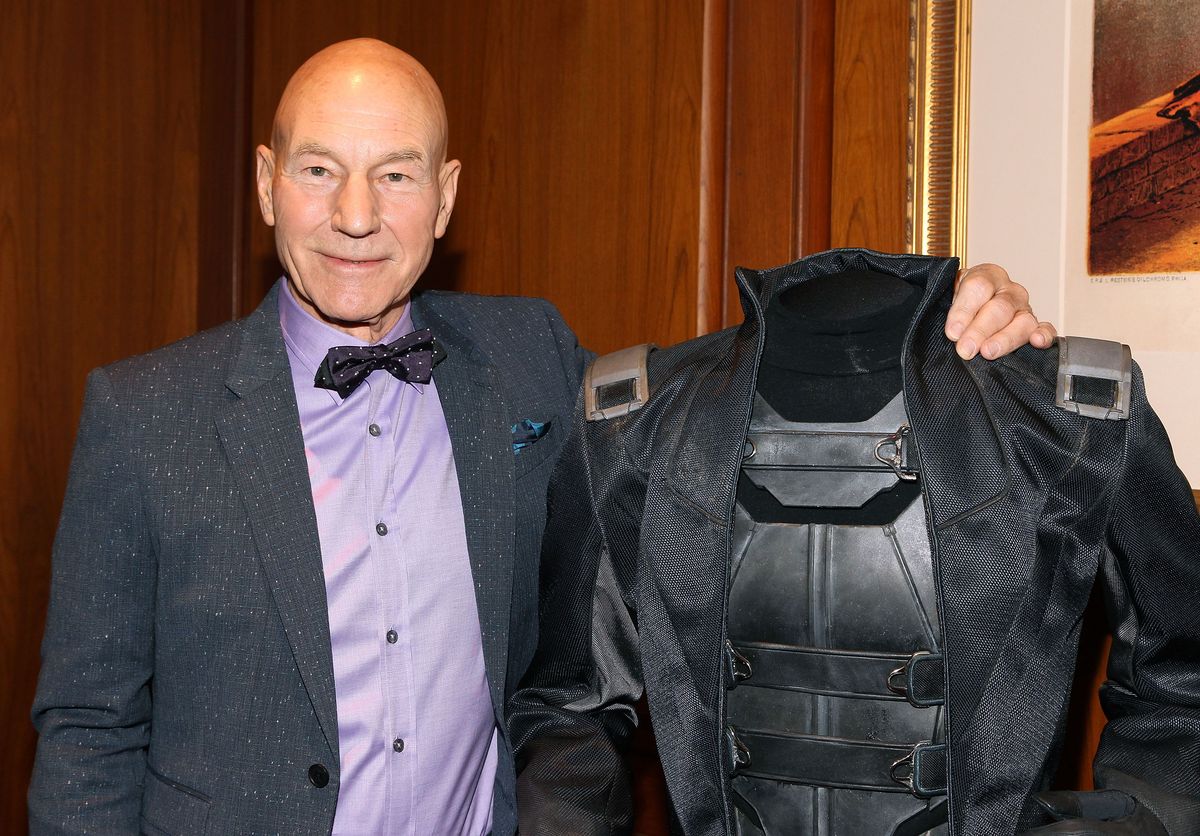 Patrick Stewart poses alongside his iconic Professor Xavier costume during a special presentation of X-Men memorabilia at the Smithsonian's National Museum of American History in Washington, D.C., on May 17, 2014.