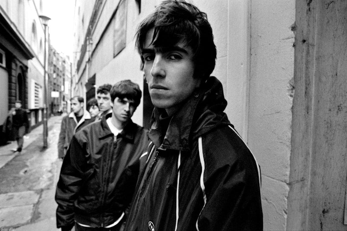 British rock band Oasis (Noel Gallagher, Liam Gallagher, Paul McGuigan, Paul Arthurs, Tony McCarroll) on Flitcroft St, London WC2, 15 March 1994