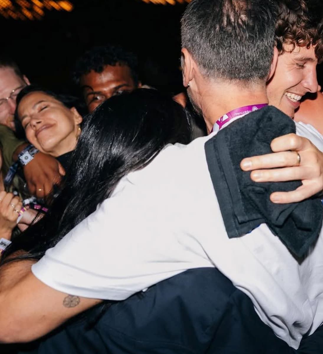 Shawn Mendes embracing Dua Lipa and her father after the show