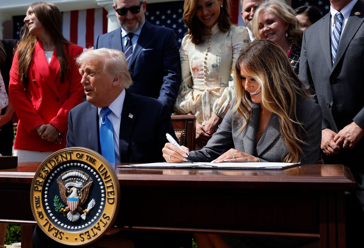 First lady Melania Trump signs the  TAKE IT DOWN Act alongside U.S. President Donald Trump