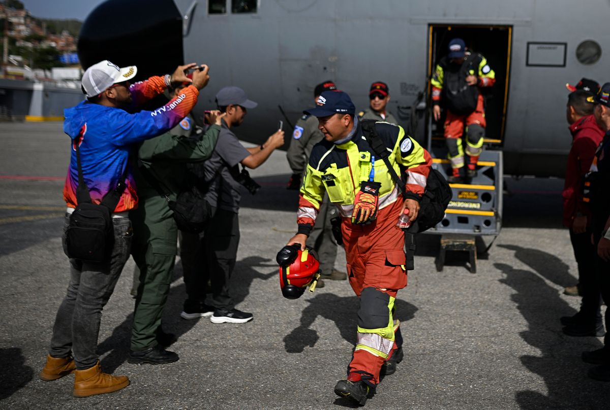 Ecuadorean firefighters of the Urban Search and Rescue (USAR) squad leave the plane on arrival at the Simon Bolivar international airport in La Guaira, Venezuela, on June 26, 2026, after deadly earthquakes struck the country.