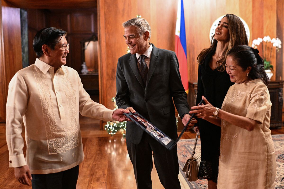 Philippine President Ferdinand "Bongbong" Marcos Jr. and First Lady Liza Araneta Marcos present a photo album souvenir to George and Amal Clooney