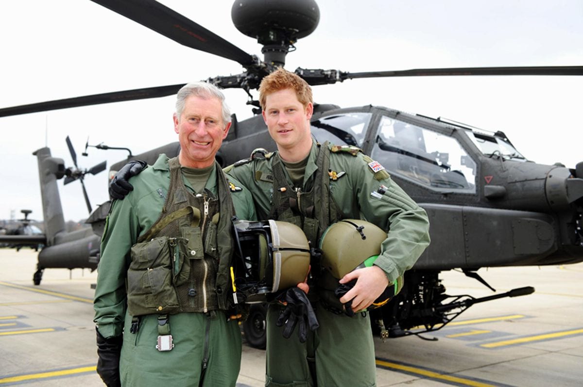 In this handout photo, dated March 21, 2011, issued by the Ministry of Defence, Prince Harry and his father, Prince Charles, Prince of Wales, stand in front of an Apache helicopter after Prince Charles was invited by the Army Aviation Centre in his role as Colonel-in-Chief of the Army Air Corps (AAC) in order to fly an Apache and to meet students on the Apache Conversion Course on March 21, 2011 in Middle Wallop, England. The announcement by St James's Palace comes a few days after the royal, a trainee Apache helicopter pilot, passed the half-decade milestone. (Photo by Richard Dawson/MoD via Getty Images)  NOTE TO EDITORS: This handout photo may only be used for editorial reporting purposes for the contemporaneous illustration of events, things or the people in the image or facts mentioned in the caption. Reuse of the picture may require further permission from the copyright holder.