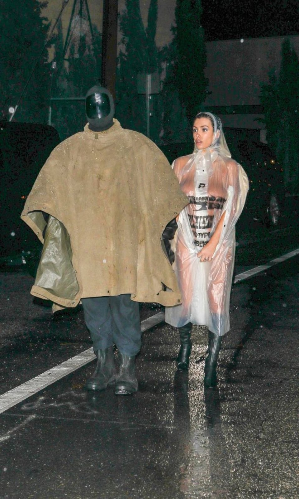 Bianca censori wears nothing but a clear raincoat in la storm