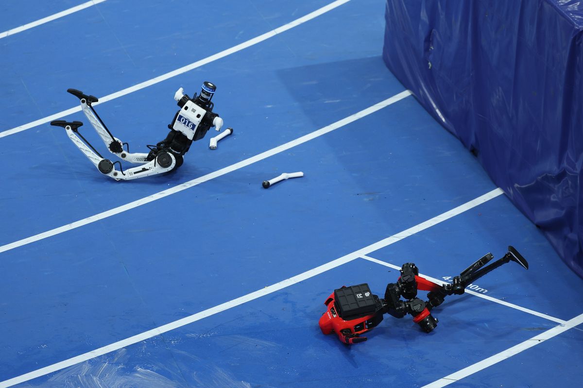 Humanoid robots crash into the crash pad at the end of a sprint in the 100 meter preliminaries