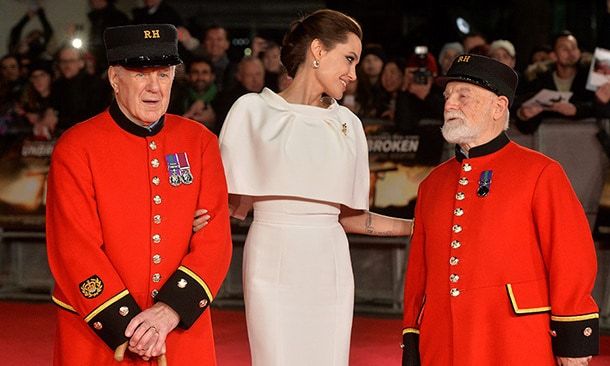 Angelina Jolie enjoys a tender moment with Chelsea pensioners, who escorted her on the red carpet