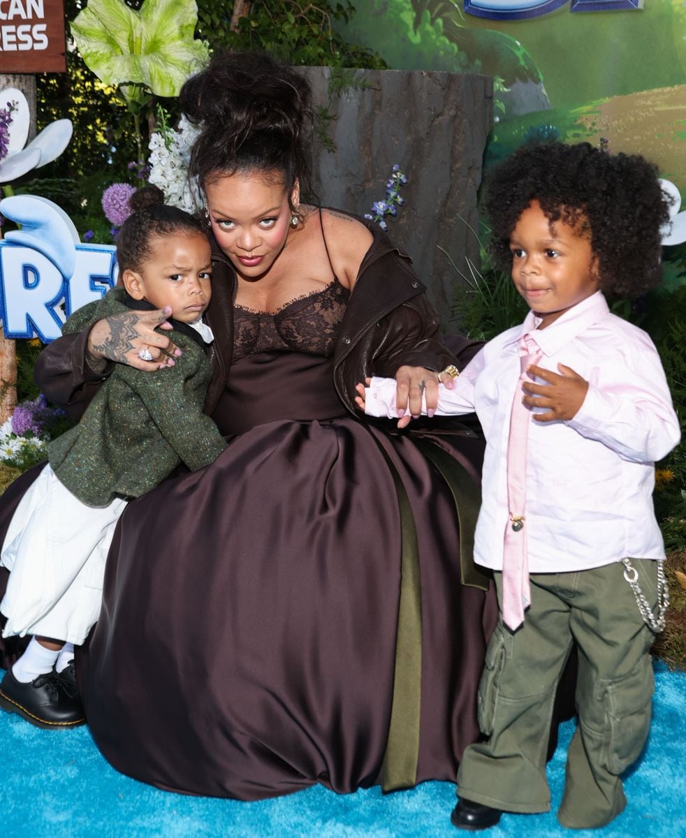 She wore a brown Saint Laurent Fall 2025 lace-detailed ensemble paired with a matching leather jacket, styling her hair in a loose high bun to stay cool and attentive to her little ones.