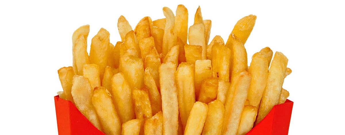 French fries in a red carton box isolated on white background.