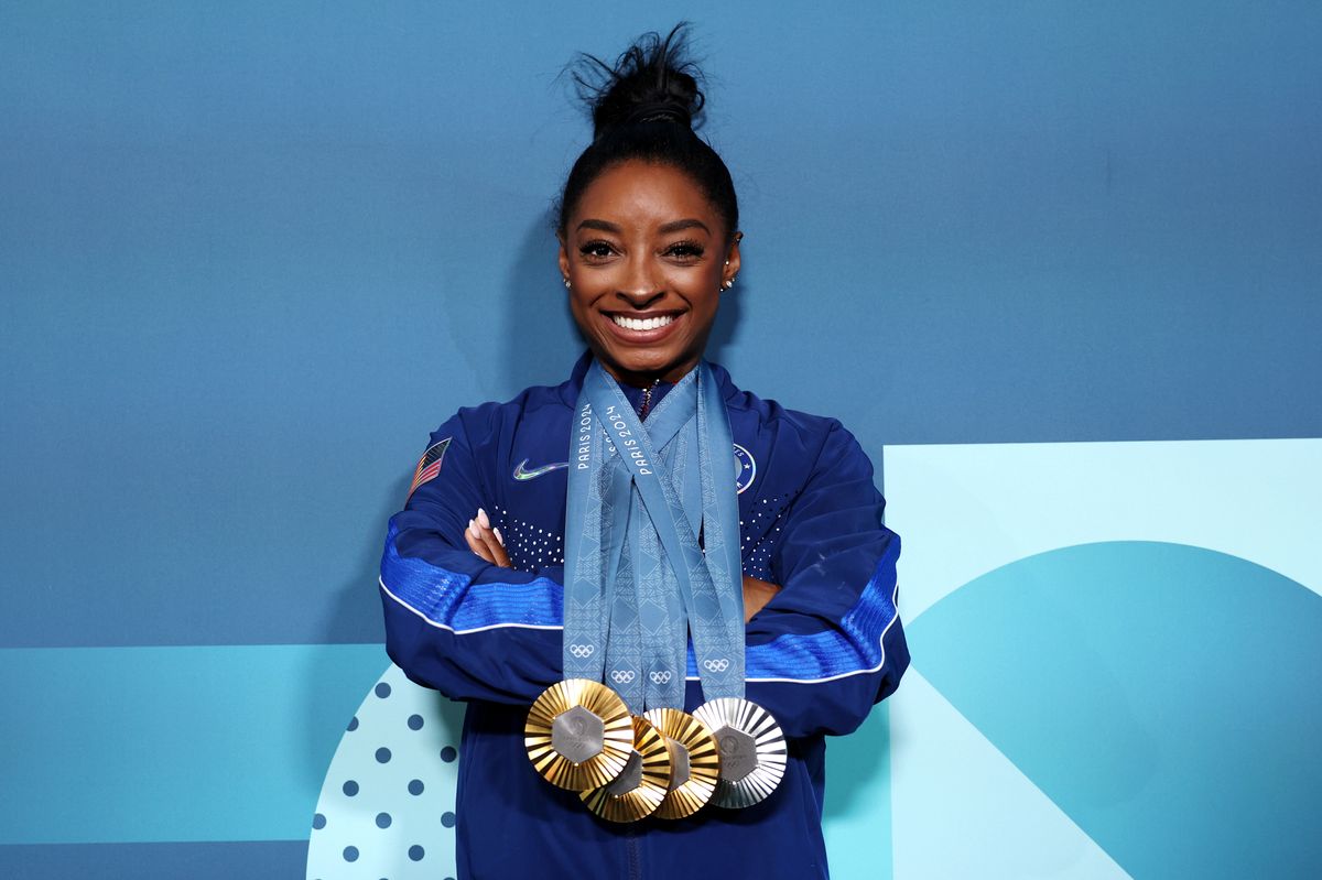Simone Biles of Team United States poses with her Paris 2024 Olympic medals following the Artistic Gymnastics Women's Floor Exercise Final on day ten of the Olympic Games Paris 2024 at Bercy Arena on August 05, 2024 in Paris, France. (Photo by Jamie Squire/Getty Images)