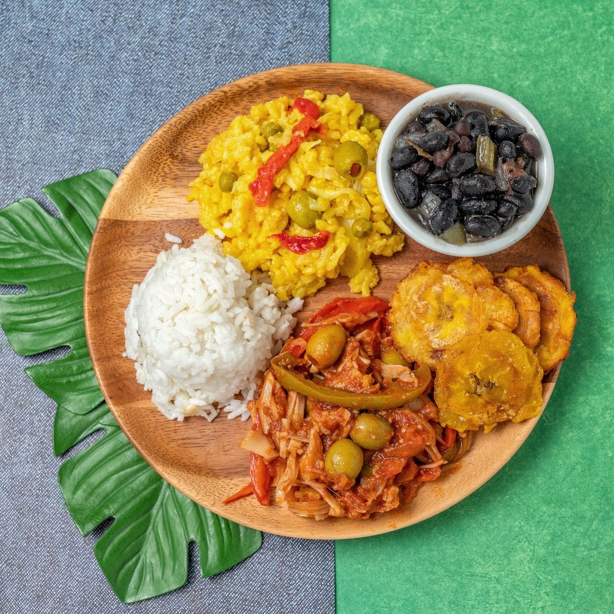 Yellow rice (arroz con pollo), ropa vieja, fried plantain, white rice, and black beans. 