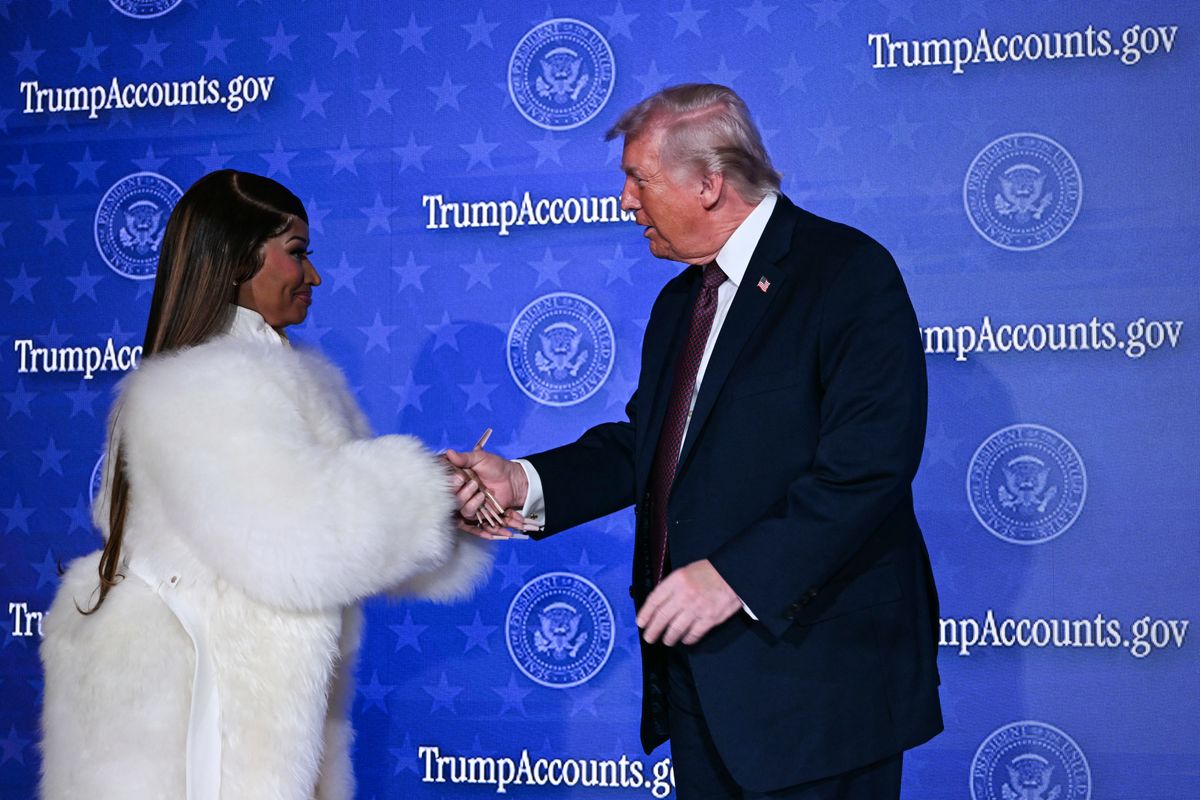 Donald Trump shakes hands onstage with  Trinidadian rapper and singer-songwriter Nicki Minaj during an event on 'Trump Accounts' at the Andrew W. Mellon Auditorium in Washington, DC.