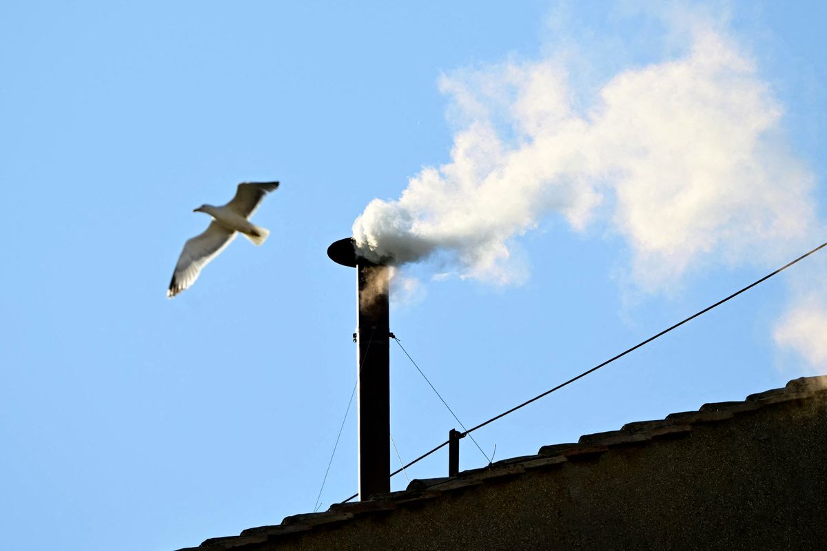 White smoke rising from the chinmey of the Sistine Chapel signaling that cardinals elected a new pope during their conclave in the Vatican on May 8, 2025. 