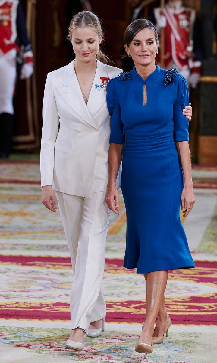 For Princess Leonor's 18th birthday on Oct. 31, 2023, Queen Letizia stepped out wearing a blue Carolina Herrera dress featuring a keyhole neckline and puff sleeves. Meanwhile, the Princess of Asturias wore a chic white pantsuit.
