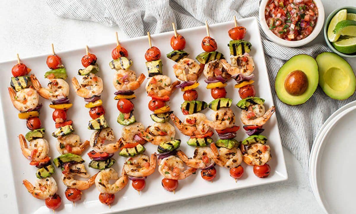 Plate of mouthwatering Grilled Shrimp Avocado Veggie Skewers.