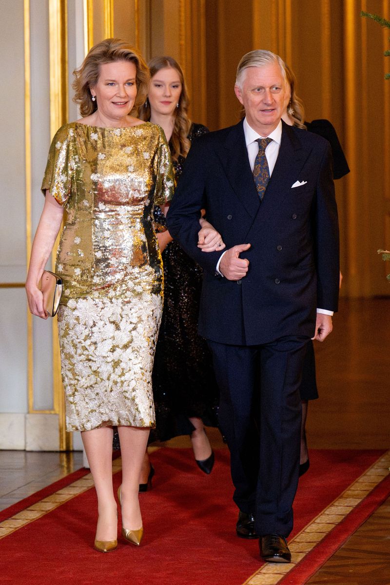 Queen Mathilde was the most daring of the night. She chose a dress that incorporates two of the most iconic elements of Christmas looks, sequins and metallic tones. 